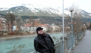 Mr. Bonzai gazes on the town of Innsbruck with the Alps in the rear, enshrouded with fog at the tops.