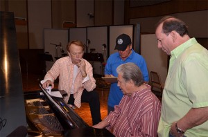 Brian works out a part at the piano with (L-R) Al, Bruce, and Jeffrey.  Photo by David Goggin.